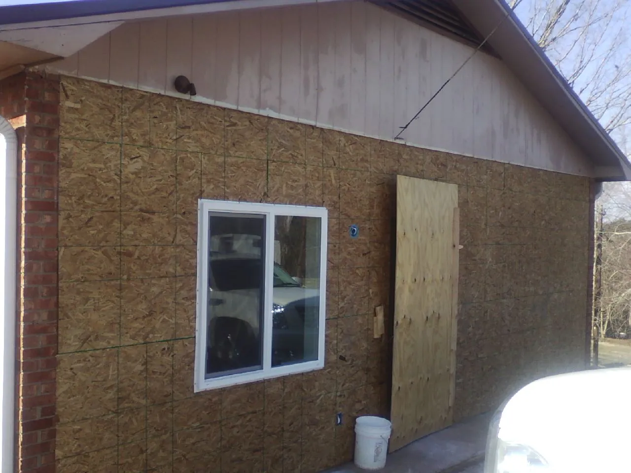 OSB sheathing on a garage addition wall before siding in Laurel Springs