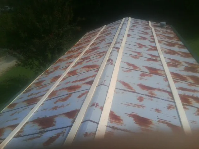 Rusted metal roof panels with new wood purlins before replacement — Storm Damage Roof Repair in Laurel Springs by Roofing Brothers